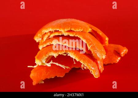 Orange peel of mandarin fruit shown on colored background. Stock Photo