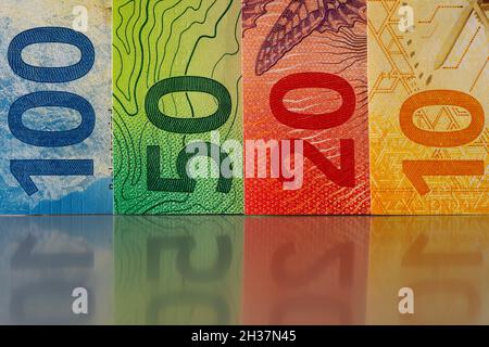 New Swiss currency of various denominations is colorful. These new banknotes are the eighth series of banknotes that were put into circulation in 2016 Stock Photo