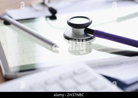 Stethoscope and stylus lying on digital tablet with electrocardiogram closeup Stock Photo