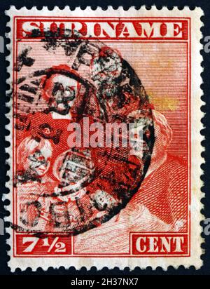 SURINAME - CIRCA 1972: a stamp printed in Suriname shows the Netherlands Royal Family, Birth of Princess Margriet Francisca of the Netherlands, circa Stock Photo