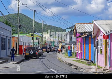 Colorful houses and shops in the main street of Hillsborough, capital city of Carriacou, island of the Grenadine Islands, Grenada in the Caribbean Sea Stock Photo