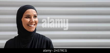 Modern Modesty. Portrait Of Smiling Young Muslim Woman In Hijab Posing Outdoors Stock Photo