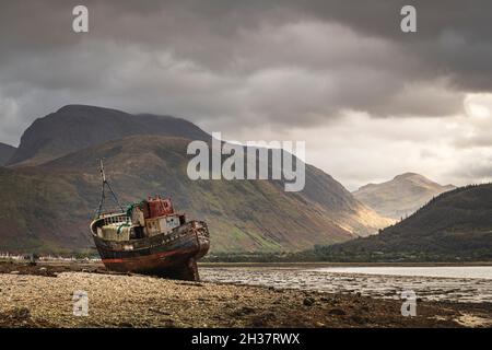 An overcast, damp autumnal 3 shot HDR image of The Corpach Wreck, MV Dayspring with Ben Nevis in the background, Lochaber, Scotland. 10 October 2021