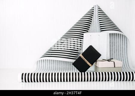 Black and white striped gift wrap background. Modern holiday gift banner with Black and white gift box and striped wrap paper. Stock Photo