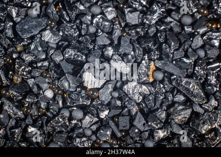 Ion exchange resins with activated carbon on a black background close-up, macro photography Stock Photo