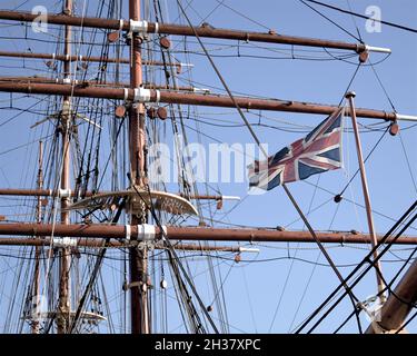 Close up of the masts, rigging and jack staff of Royal Research Ship (RRS) Discovery which is permanently berthed in Dundee, Scotland. Stock Photo