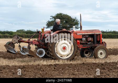 Vintage tractor working at The Great All England Ploughing Match held in Droxford, Hampshire, England, UK, October 2021 Stock Photo