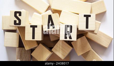 The word START written on wooden blocks against a white background Stock Photo