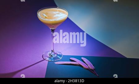 Performance with alcoholic drink on purple background. Stock footage. Alcoholic cocktail on elegant background. Beautiful decoration of alcoholic Stock Photo