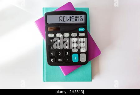 Revising, text on the calculator. Multi Colored notepads on white background Stock Photo