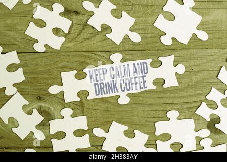 Sign displaying Keep Calm And Drink Coffee. Word Written on encourage person to enjoy caffeine drink and relax Building An Unfinished White Jigsaw Stock Photo