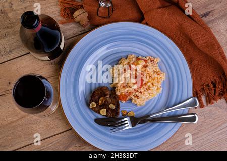 Tomato risotto with leek and Sicilian lemon and a bottle and a glass of sparkle wine - top view Stock Photo