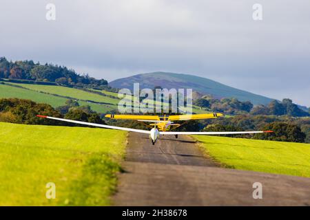 A Glaser-Dirks DG200 glider on aerotow behind a Eurofox tug. Lleweni Parc gliding site. Denbighshire, Wales. Stock Photo