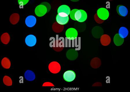 Multicolored bokeh circles on a dark background. Defocusing effect. Decorative background Stock Photo
