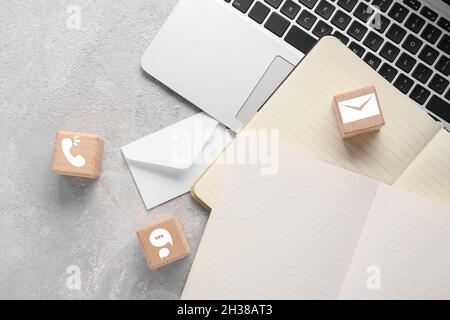 Cubes with digital technology icons, notebooks and laptop on grunge background Stock Photo