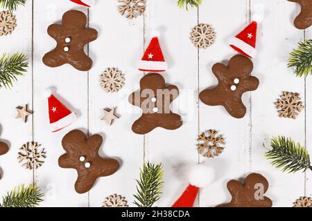 German gingerbread in shape of men glazed with chocolate between Christmas decoration Stock Photo