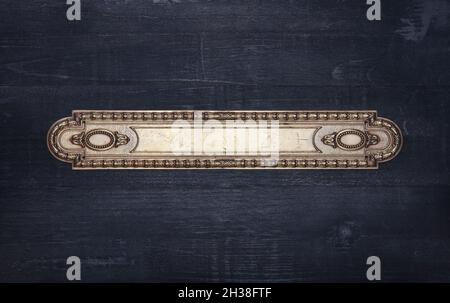 Ornate victorian metal frame on a black wood background Stock Photo