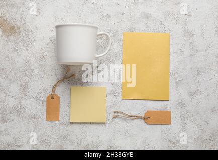 Composition with blank cup, cards and tags on light background Stock Photo