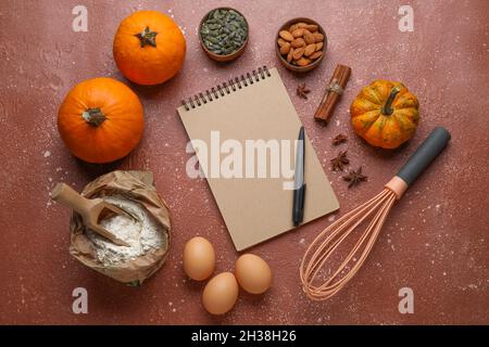 Ingredients for preparing pumpkin pie and notebook on table Stock Photo