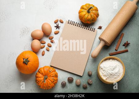 Ingredients for preparing pumpkin pie and notebook on table Stock Photo