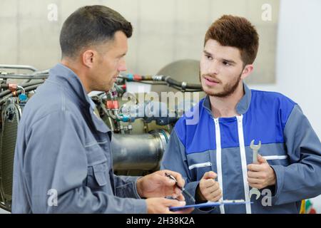 two engineers working on engine Stock Photo