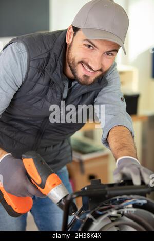 male technician using a cordless screwdriver Stock Photo