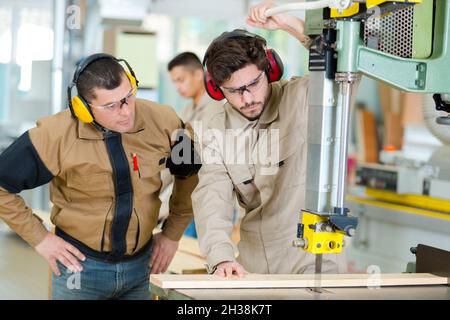 male operator using a milling machine for cutting wood Stock Photo