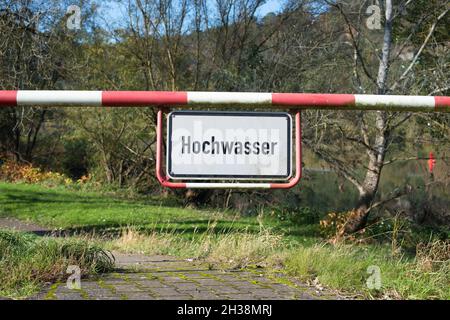 High water sign in german language, next to the river Moselle in Trier, warning for flood, climate change, enviromental issue Stock Photo