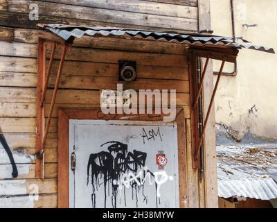 Russia, Moscow, October 2020. A fragment of an old dilapidated wooden house , an entrance with a visor. Stock Photo