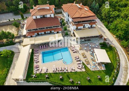 Aerial drone view over country hotel complex with outdoor pool and bar. Larissa, Greece. Stock Photo