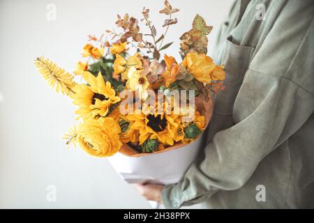 Hand holding bunch bright autumn orange bouquet Stock Photo