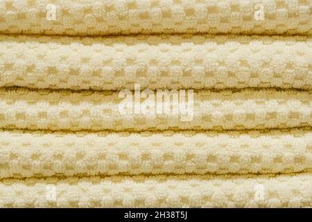 Stack of yellow towels close up. Home decor and comfort concept Stock Photo
