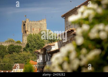 Bragança, Portugal - June 26, 2021: Keep of Bragança Castle in Portugal, seen from the historic center with facades of old buildings in the foreground Stock Photo