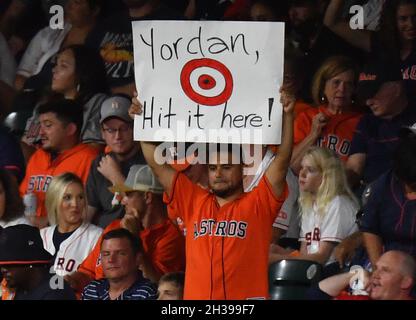 A Houston Astros fan holds up her wish list sign before game 2 of