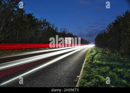 Light trails on a busy trunk road into the city of cambridge early morning, as commuters travel to Cambridge city Stock Photo