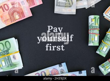 PAY YOURSELF FIRST Quote Euro bills are creative layout. Business concept, development perspective. Flat lay. Top view. Minimal creative style pattern Stock Photo