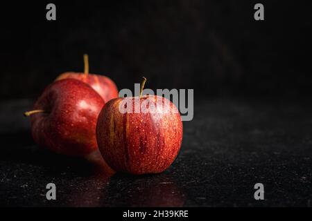 Fresh autumn apples on black table. Stock Photo