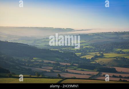 Early morning mist clearing over the edge of Exmoor, from Bossington Hill, Somerset, south west England UK Stock Photo
