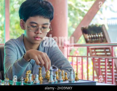 Concentrated serious boy developing chess gambit, strategy ,playing board  game to winner clever concentration and thinking child while playing chess.  Learning, tactics and analysis concept. Free Photo