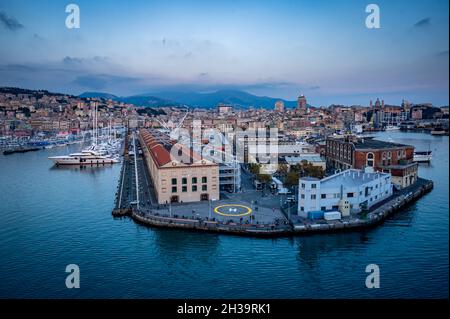 GENOA, ITALY - October 21 2021: Congress Centre in Genoa historic cotton warehouses in the Old Port in Genova, Italy. Sea view and yachts at sunset. Stock Photo