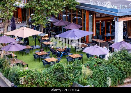 The Crew Room Cafe Bar In South Bank Waterloo With A Few Customers Relaxing And Talking Under Outside Umbrellas In The Beer Garden Stock Photo