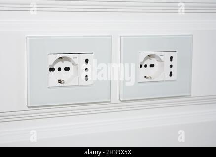 Modern outlet plug on the white wall for TV. Socket and European Power in the New Flat. Stock Photo