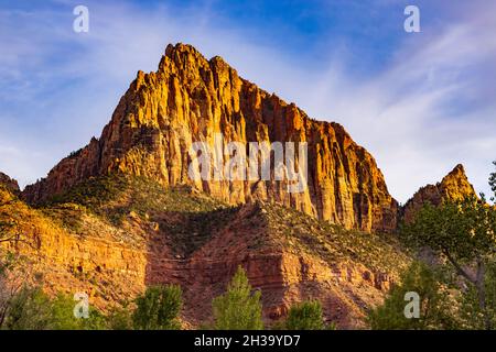 The golden light of the setting sun lights up The Watchman, a majestic rock formation in Zion National Park, Springdale, Washington County, Utah, USA. Stock Photo