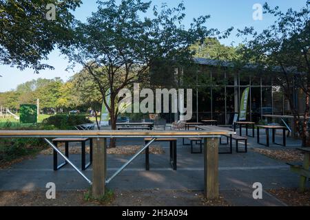 Seating area outside The Pavillion cafe and community centre and studio at Havenstoke Park on the Graylingwell development in north Chichester, West S Stock Photo