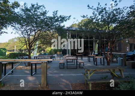 Seating area outside The Pavillion cafe and community centre and studio at Havenstoke Park on the Graylingwell development in north Chichester, West S Stock Photo