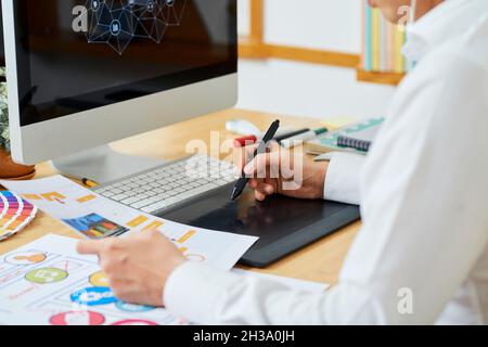 Graphic designer creating illustration for innovative project of his client Stock Photo