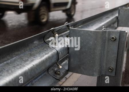 underscrewed nuts and bolts in highway road railing Stock Photo