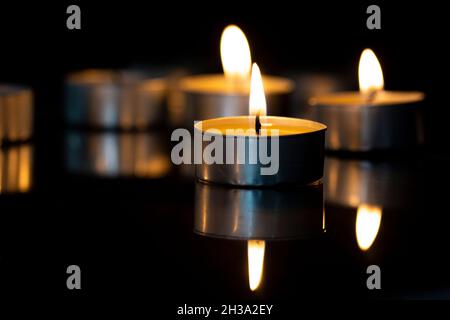 small candles are burning on the mirror Stock Photo