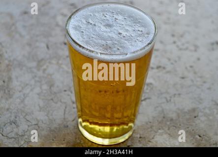 A Canadian lager in a glass on the table