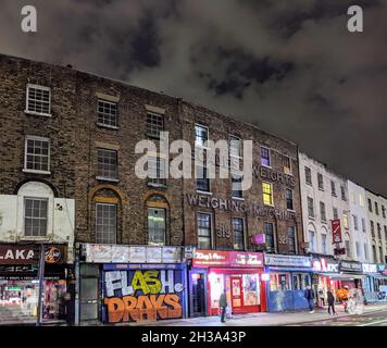 One of London's best ghost signs can be seen clearly in this photo taken at night near Kings Cross station Stock Photo